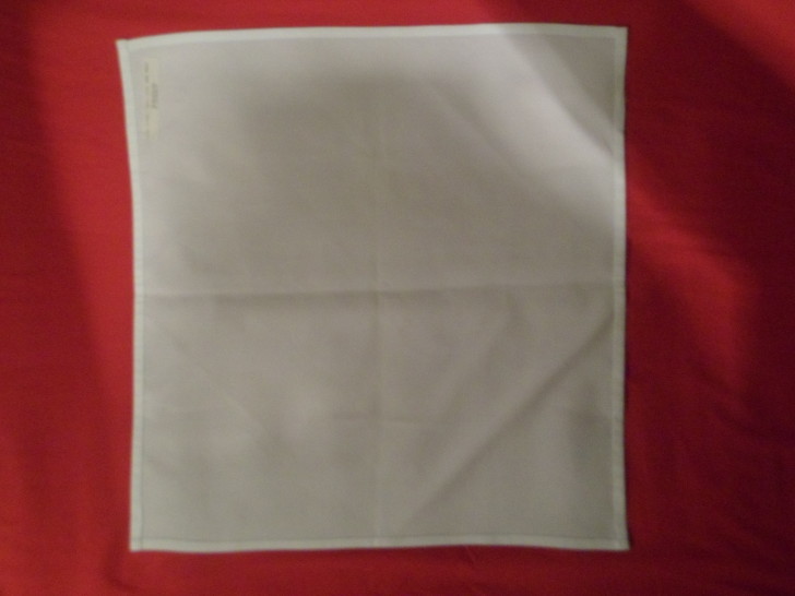 Folding napkins for silverware Step One Lay the napkin flat out in front of you.
