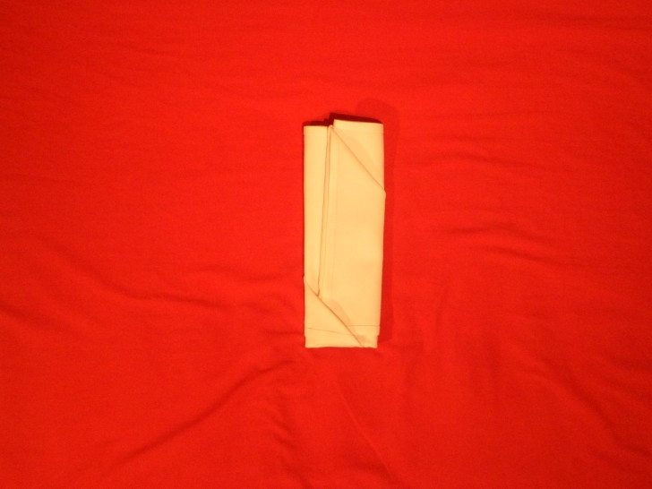 Folding napkins for silverware Step Eight Fold the right side over and tuck it in to the left hand side fold.