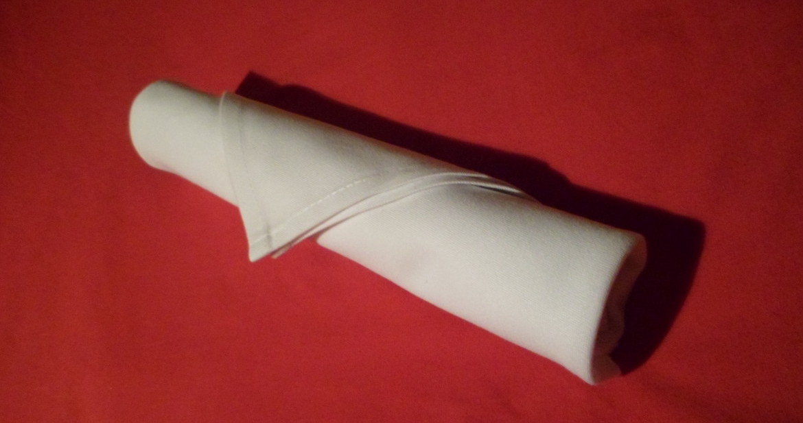 folding napkins for silverware. An extremely easy fold and a great way to keep a table arrangement tidy