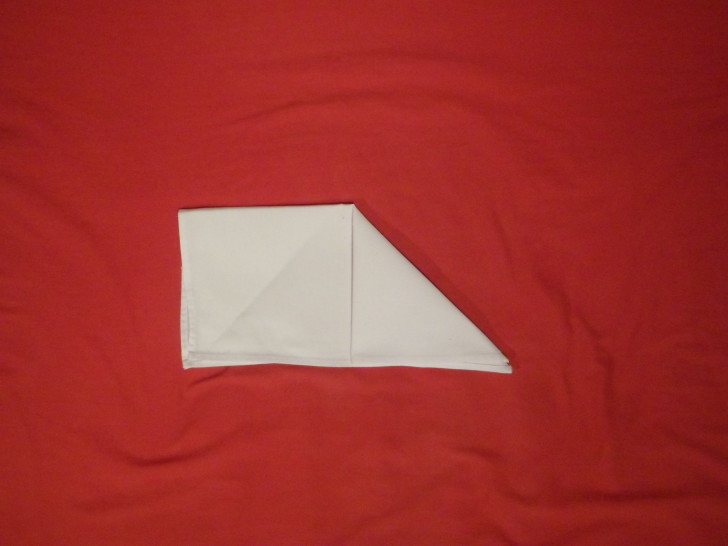 Napkin Folding Instructions The Sail Fold Step three fold the top right corner down to the bottom edge