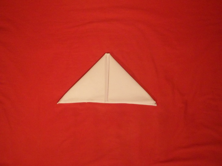 Napkin Folding Instructions The Sail Fold Step  Four fold the left corner over making a triangle 