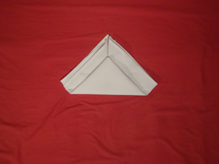 How To Fold Napkins The Crown Fold Step Five Fold the bottom up leaving about an inch from the top