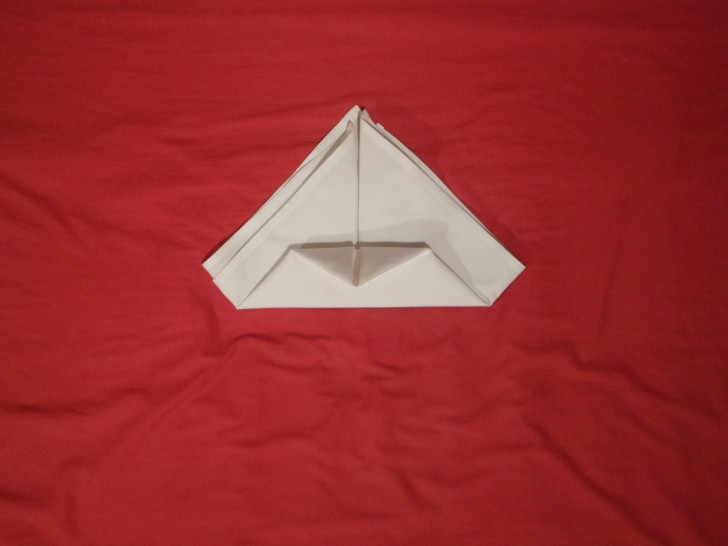 How To Fold Napkins The Crown Fold Step Six From the fold you just made take the point and fold it back on its self so its just touching the bottom. You may find it helps to use an iron if the napkin wont stay.