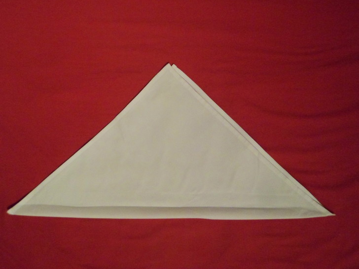 Free Napkin Folding Instructions Candle Fold Step Two fold the napkin in half diagonally 