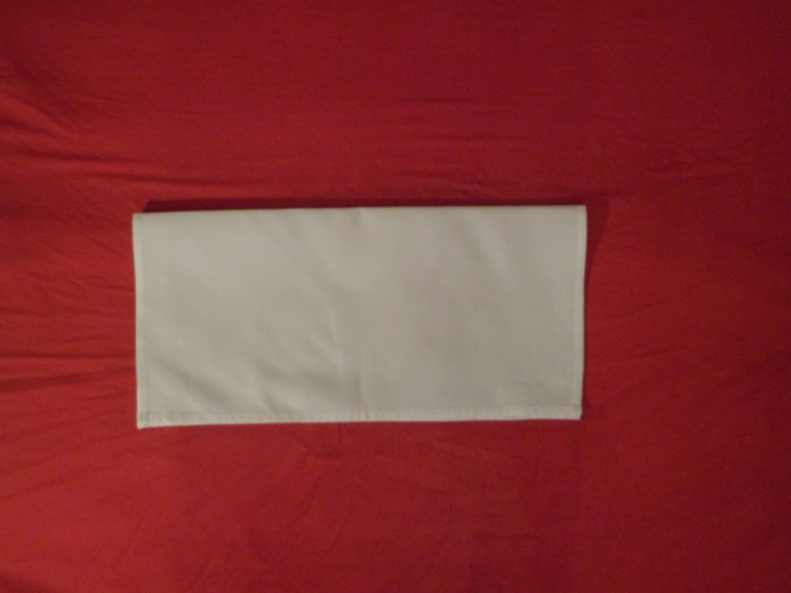 How to fold napkins arrowhead. Step two Fold the napkin in half towards yourself. 