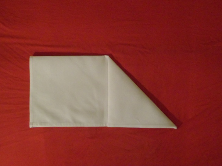 How to fold napkins arrowhead. Step three fold the top right corner down to the centre on the open bottom edge of the napkin. 