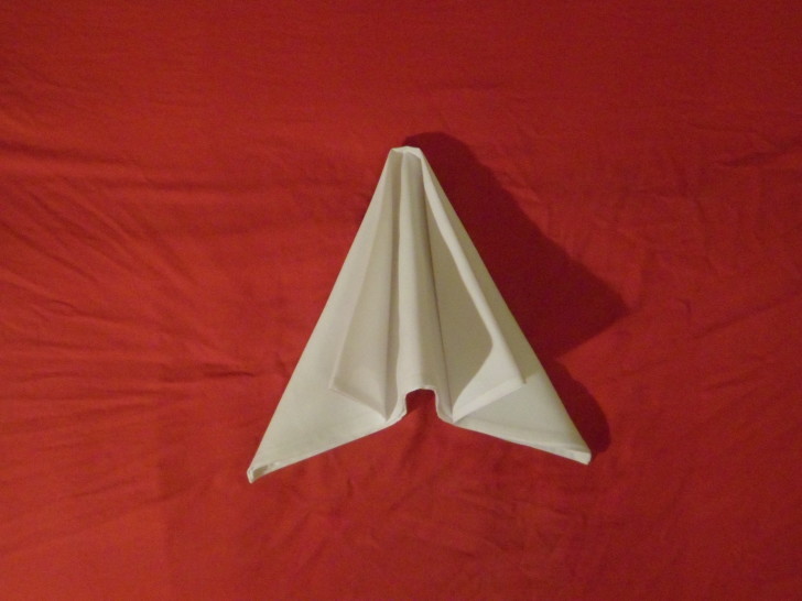 how to fold napkins Arrowhead eight place your hands flat on the top of the napkin fold and push the two outsides together causing the middle to rise up.