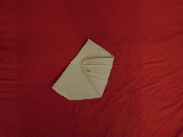 Napkin Origami The Diamond Fold Step Nine Fold the bottom right corner in about two thirds of the way