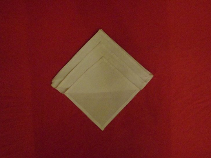 Napkin Origami The Diamond Fold Step Six Repeat the same as the previous steps only leaving it slight lower once more