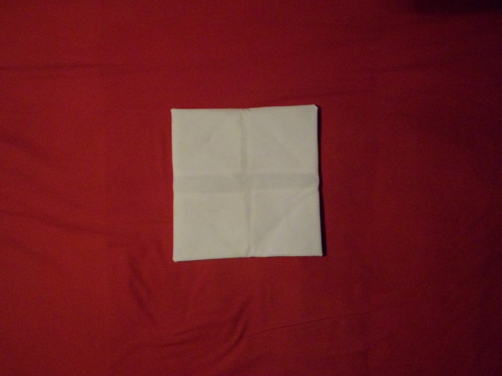 Napkin Folding Rose Fold Step Ten flip the napkin over. Ensuring that you don't let if fall apart.