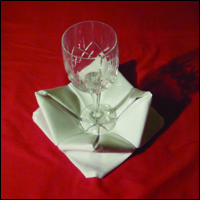 beautiful napkin fold the rose fold completed with wine glass